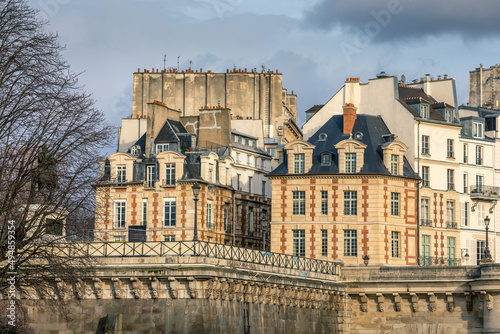 Paris, France - March 14, 2021: Beautiful Haussmann building near Place Dauphine and Pont Neuf bridge in Paris