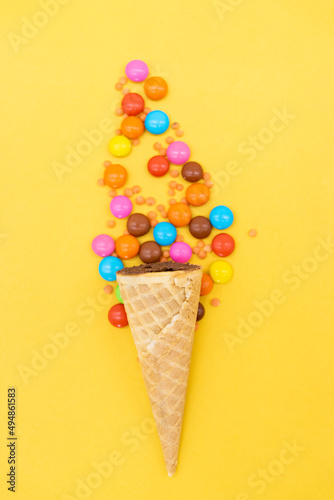 crispy candy over on yellow background, top view
