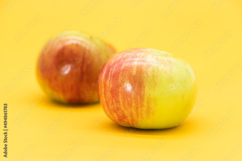 Red apple isolated on yellow background. Clipping path. Fresh organic apple collection. Red apple isolated on yellow background. Clipping path. Fresh organic apple collection.