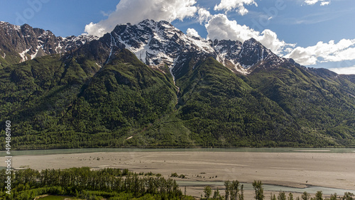 Beautiful shot of a snowy mountain with a green forest in Palmer, Alaska