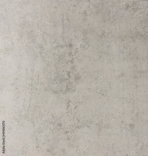 A worn gray concrete wall with scratches and stains. Gray background with texture. The old wall. 
