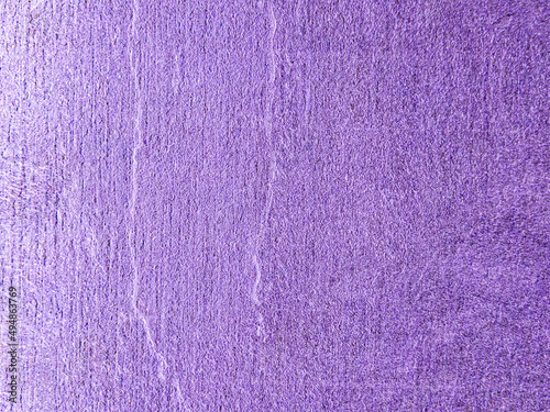 Worn purple surface with vertical noise and cracks. Purple background with texture. The old wall. 