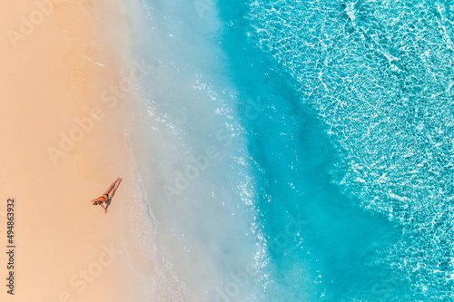 Photos Aerial view of a girl on the beach on Maldives island