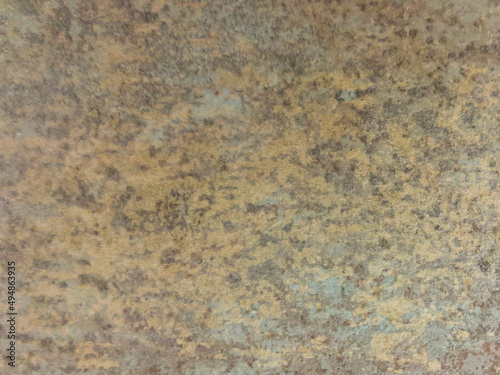 An old brown wall with dark spots. Brown, vintage background with a mottled texture. 