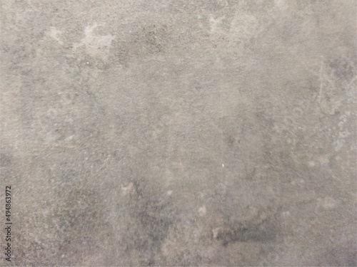 The smooth concrete wall is gray with spots. Gray background with texture. Worn surface. 