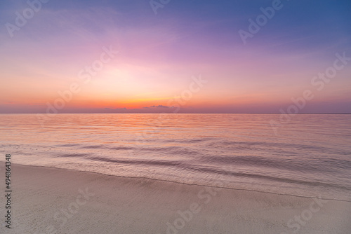 Closeup sea sand beach. Amazing empty beach landscape. Inspire tropical island seascape horizon. Orange golden purple sunset sunrise sky tranquil sunlight. Summer vacation travel holiday copy space