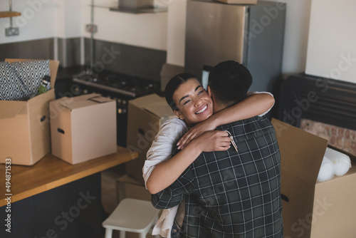 Mid adult couple hugging in their new home photo