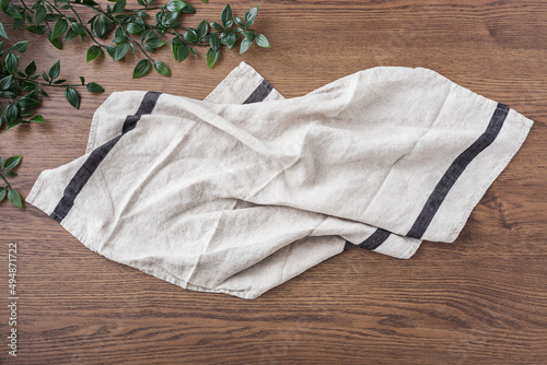 Linen cloth, kitchen towel, tablecloth on dark wood table photo