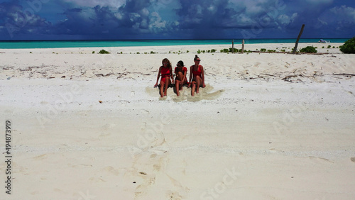 Caucasian women from Russia on the beach sand in Fulhadhoo Island, the Maldives photo