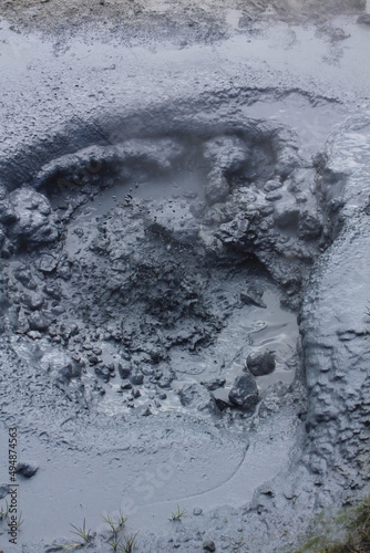 Fototapeta Naklejka Na Ścianę i Meble -  Close up: Hot bubbling volcanic mud pot, steam blur, concept: heat, power, Earth formation (vertical), Hveragerdi, Iceland