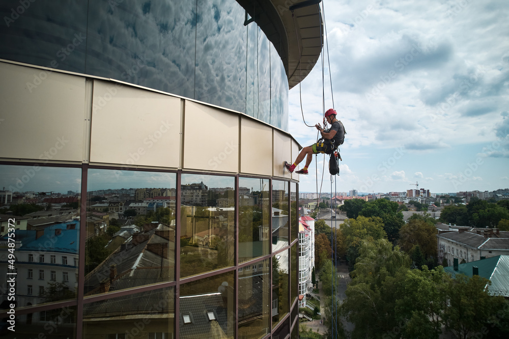 Picture Idea: Industrial Mountaineering Worker Cleaning Glass Window Of High Rise