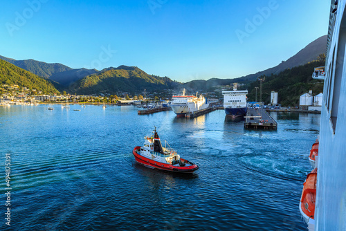 View of the town of Picton, New Zealand, from a cruise liner in Queen Charlotte Sound. A tugboat is returning to port