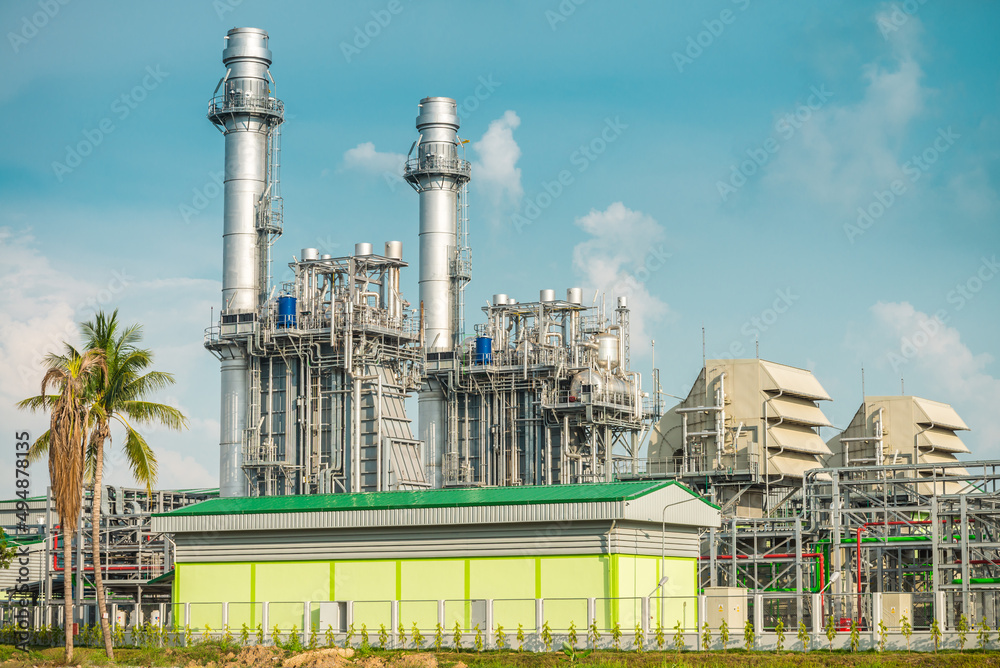 Natural gas electric power plant with blue sky sunny day background. Electricity, energy technology concept. Natural gas electric power plant with blue sky sunny day background. Electricity, energy technology concept.