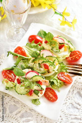 Easter breakfast with eggs stuffed with vegetable salad and mayonnaise