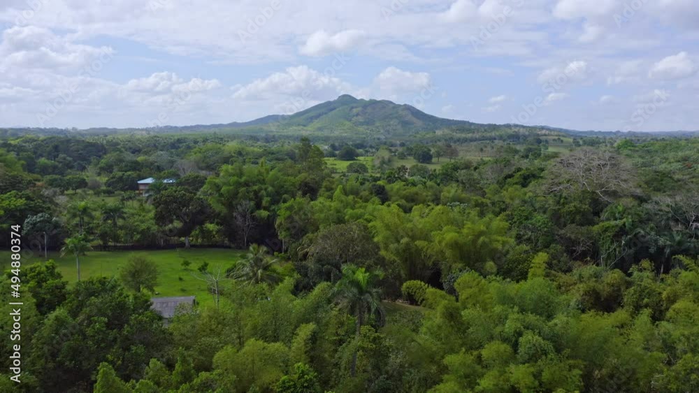 Aerial forward flight over tropical scenery of Bayaguana and mountain in background Aerial forward flight over tropical scenery of Bayaguana and mountain in background