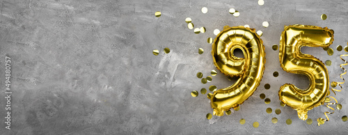 Yellow foil balloon number, number ninety-five on a concrete background. Greeting card with the inscription 95. Anniversary concept. for anniversary, birthday, new year celebration. banner,