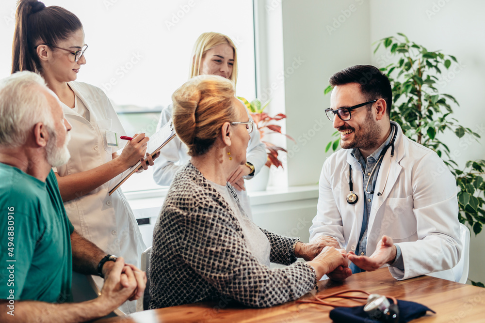 Fototapeta premium Group of young doctor during home visit senior people