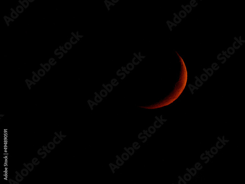 Fotografija Closeup shot of a red crescent moon on a completely black sky