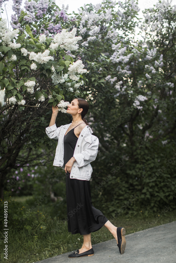 woman sniffing the scent of lilacs