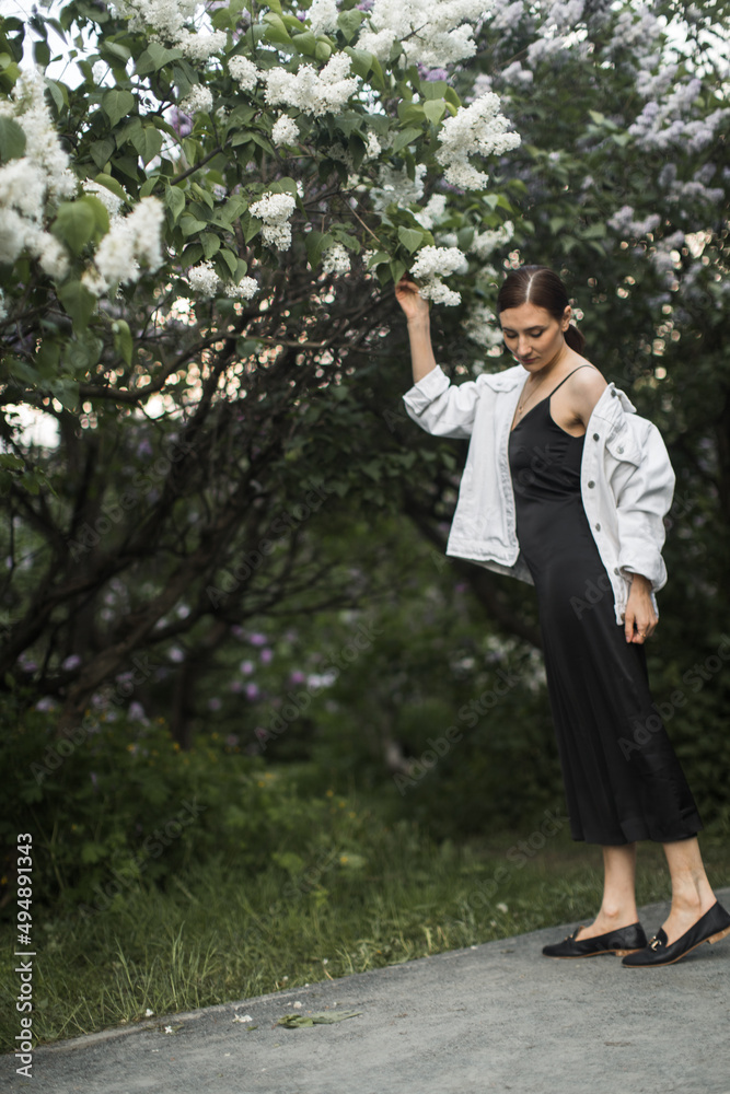 woman sniffing the scent of lilacs