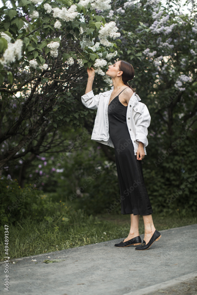woman sniffing the scent of lilacs