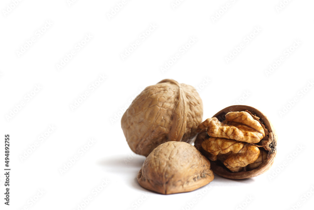 Ripe cracked walnuts on a white background. Ripe cracked walnuts on a white background.