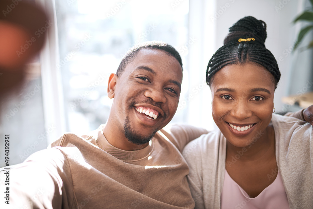 Smile for the camera. Portrait of a young couple taking selfies together at home. Smile for the camera. Portrait of a young couple taking selfies together at home.