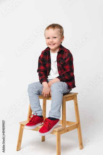 Portrait of a little smiling boy on white plain background - preschool kid