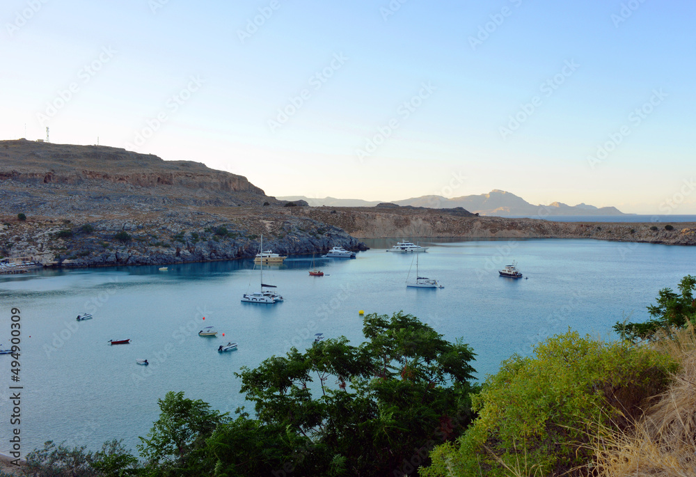 Lindos, Greece view over the bay with lindos beach and boats Lindos, Greece view over the bay with lindos beach and boats
