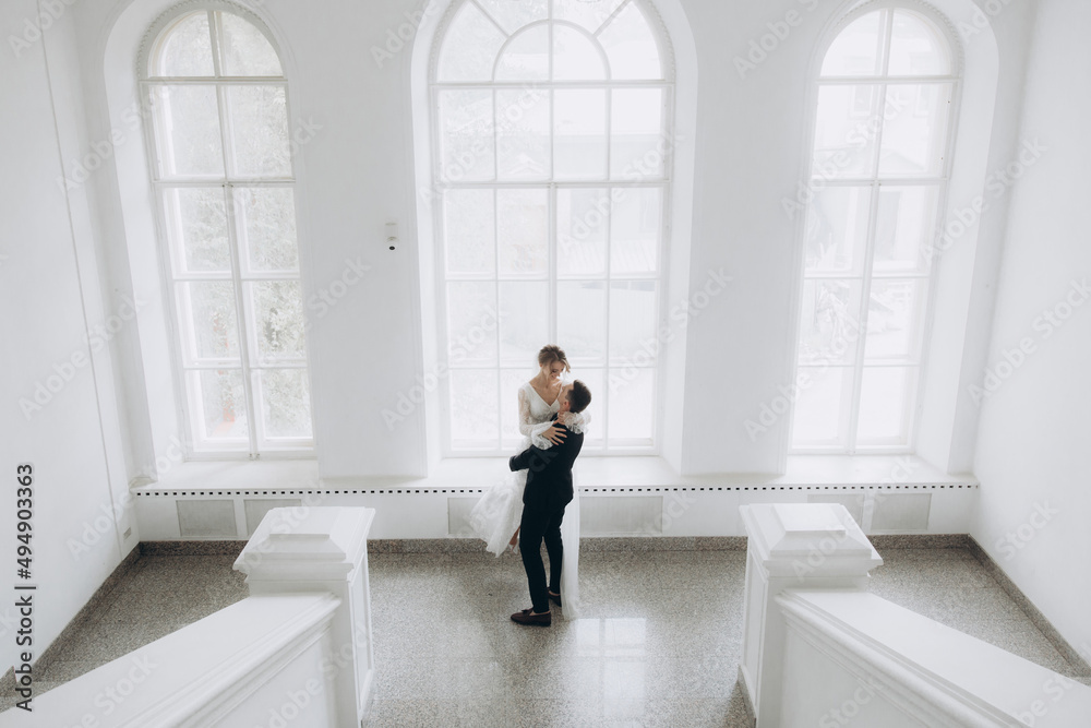 Wedding of a beautiful, stylish couple, a bride in a white wedding dress and a groom in a black suit, tuxedo. Wedding of a beautiful, stylish couple, a bride in a white wedding dress and a groom in a black suit, tuxedo.