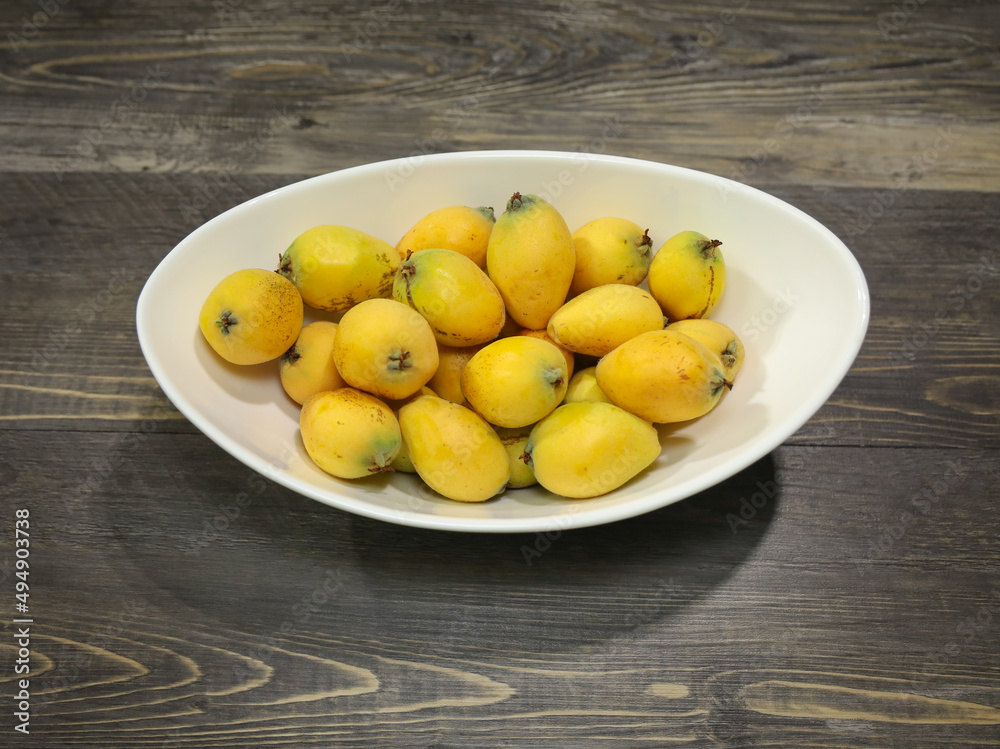 A bowl with ripe loquats or Japanese plums. A bowl with ripe loquats or Japanese plums.