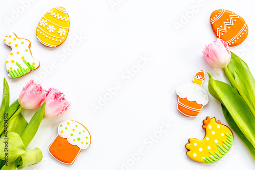 Easter bunny cookies with tulips flowers, top view