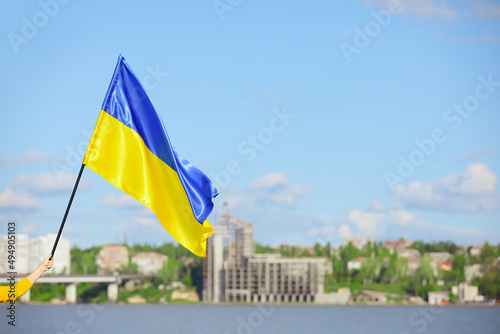 Woman holding national flag of Ukraine outdoors