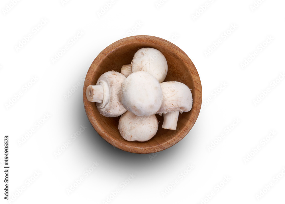 A top view of a wooden bowl full of Champignon, white button mushrooms isolated against a white background