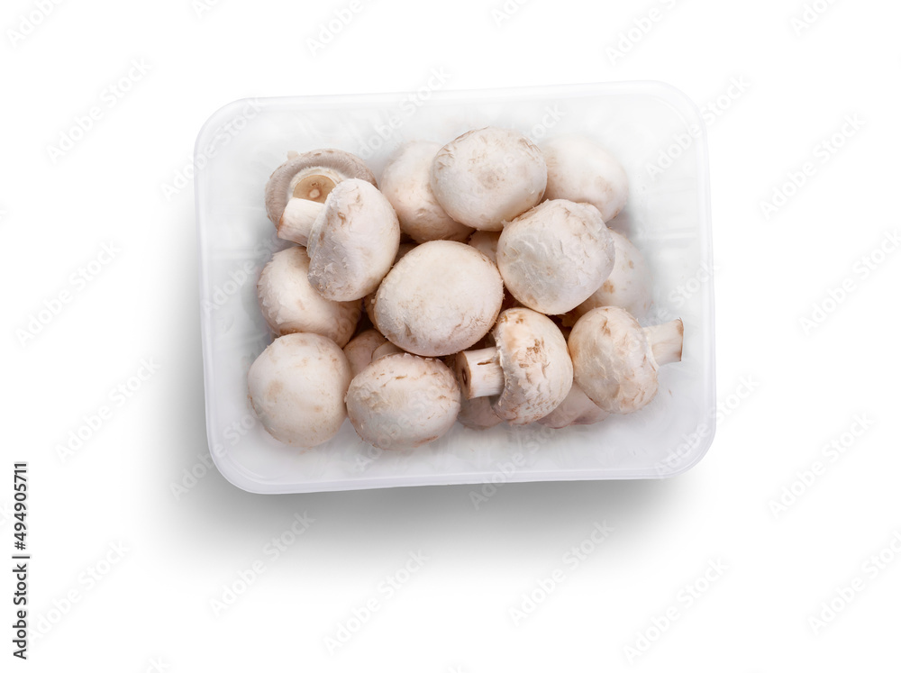 A top view of a punnet of Champignon, white button mushrooms isolated against a white background. A top view of a punnet of Champignon, white button mushrooms isolated against a white background.