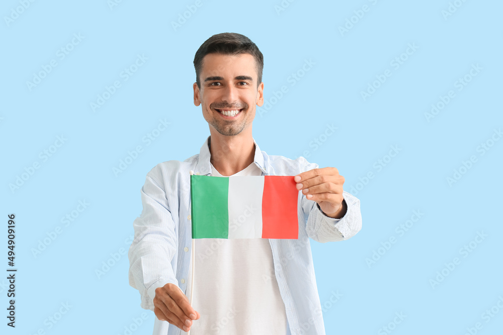 Young man with Italian flag on color background Young man with Italian flag on color background