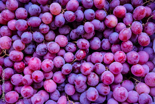 Photos Close up of raw organic sweet red grapes background.