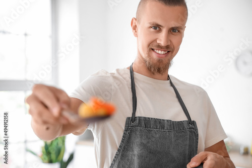 Handsome young man holding ...
