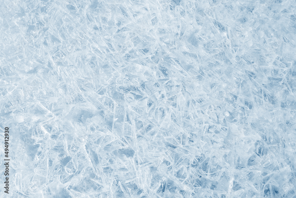 Obraz premium Ice background texture. Frozen water in various geometric abstract shapes. Seasonal natural effect. Cold weather. The surface of the winter water reservoir.