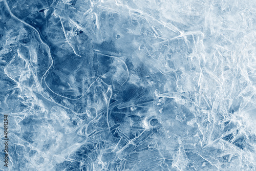 Ice background texture. Frozen water in various geometric abstract shapes. Seasonal natural effect. Cold weather. The surface of the winter water reservoir.