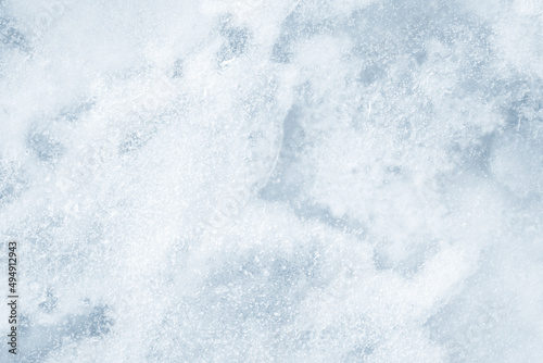 Ice background texture. Frozen water in various geometric abstract shapes. Seasonal natural effect. Cold weather. The surface of the winter water reservoir.