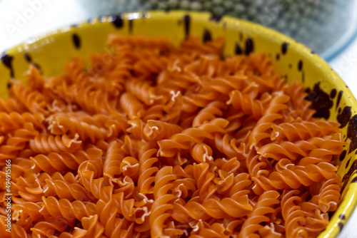 Closeup of dry fusilli pasta with carrot flawor photo