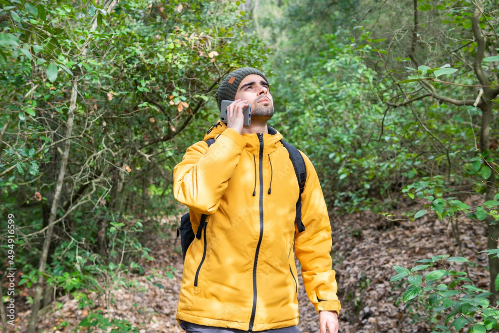 Man talking phone in forest