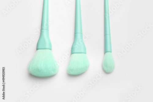 Beautiful makeup brushes on white background  closeup