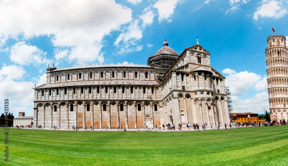 Picturesque landscape with San Giovanni Baptistery, part of cathedral or Duomo di Santa Maria Assunta near famous Leaning Tower in Pisa, Italy. fascinating exotic amazing places. Piazza dei Miracoli.