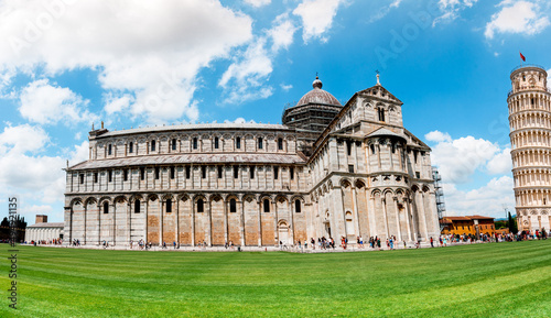 Picturesque landscape with San Giovanni Baptistery, part of cathedral or Duomo di Santa Maria Assunta near famous Leaning Tower in Pisa, Italy. fascinating exotic amazing places. Piazza dei Miracoli.