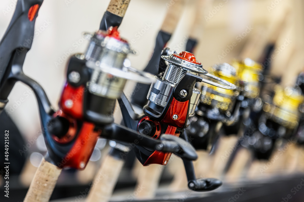 assortment of inertia-free fishing reels on the counter