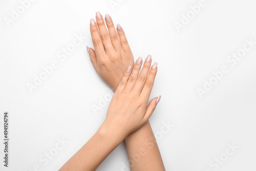 Young woman with stylish manicure on white background, closeup