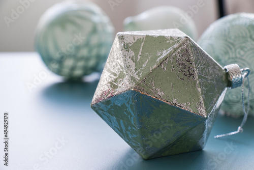 Geometric figure silver icosahedron isolated on the blue background photo