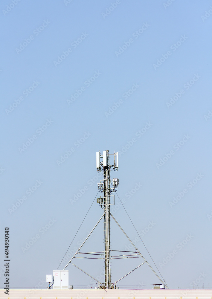 5g mobile telephone relay standing on the roof of a residential building